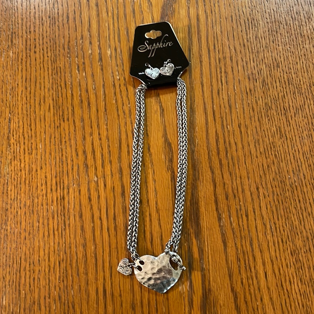 Sapphire silver colored heart necklace and matching earrings.